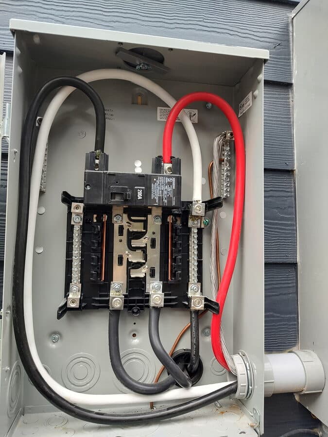 Electrician performing electrical panel repair in a Huntsville, AL home for A2Z Plumbing, Gas and Electric